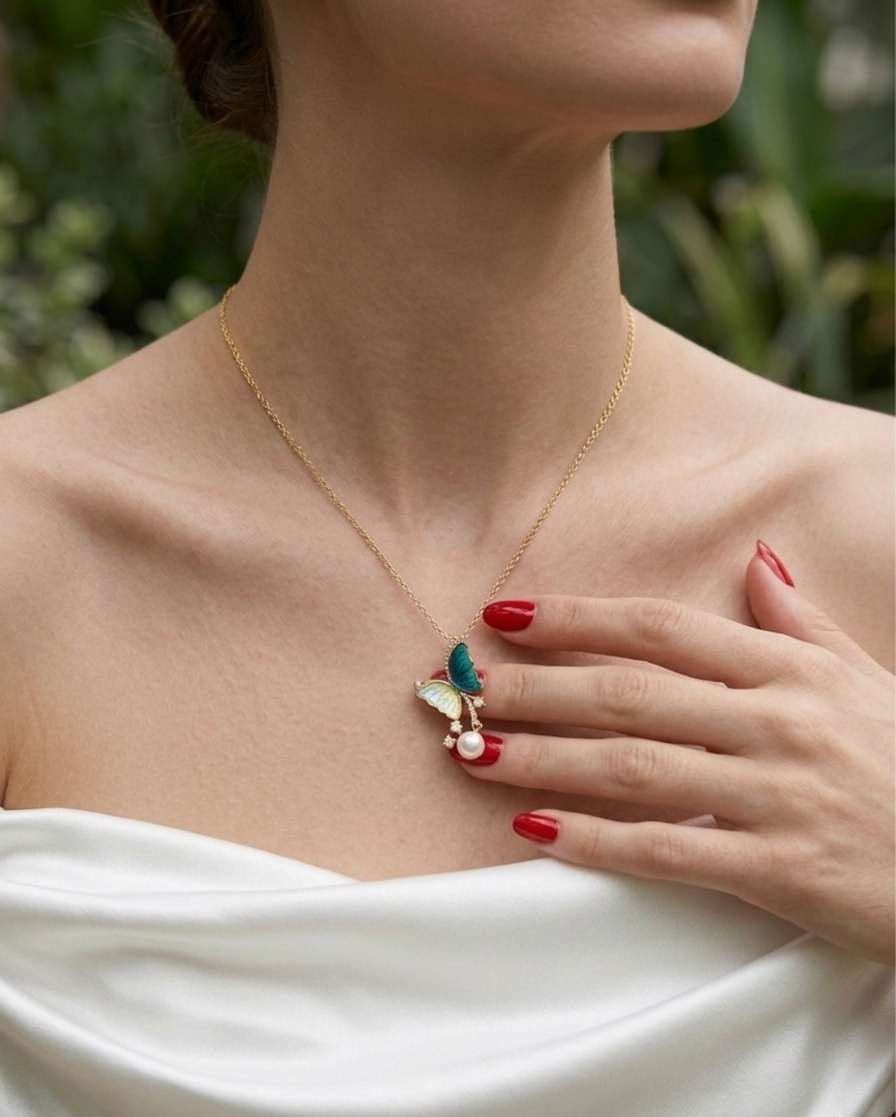 Woman wearing a delicate necklace with a butterfly pendant, set against a blurred natural background.