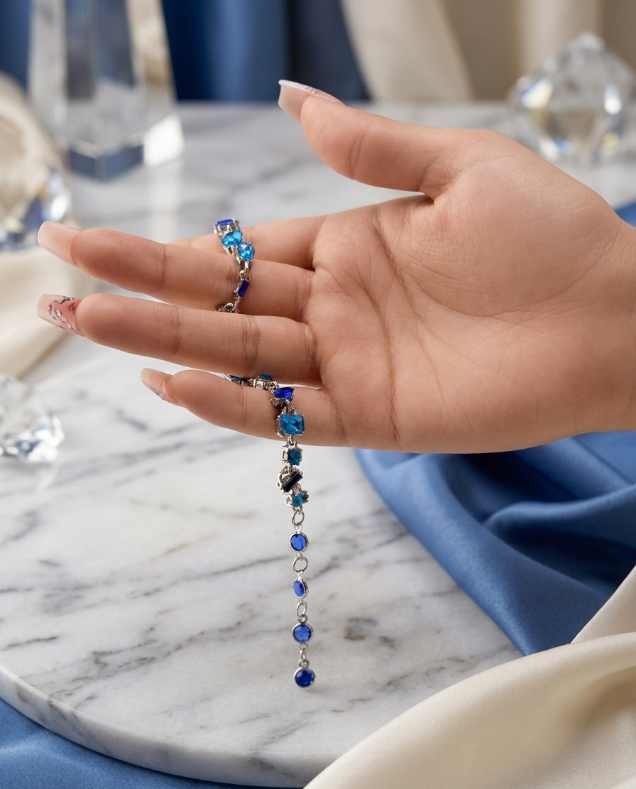 Hand wearing a blue beaded bracelet on a marble surface
