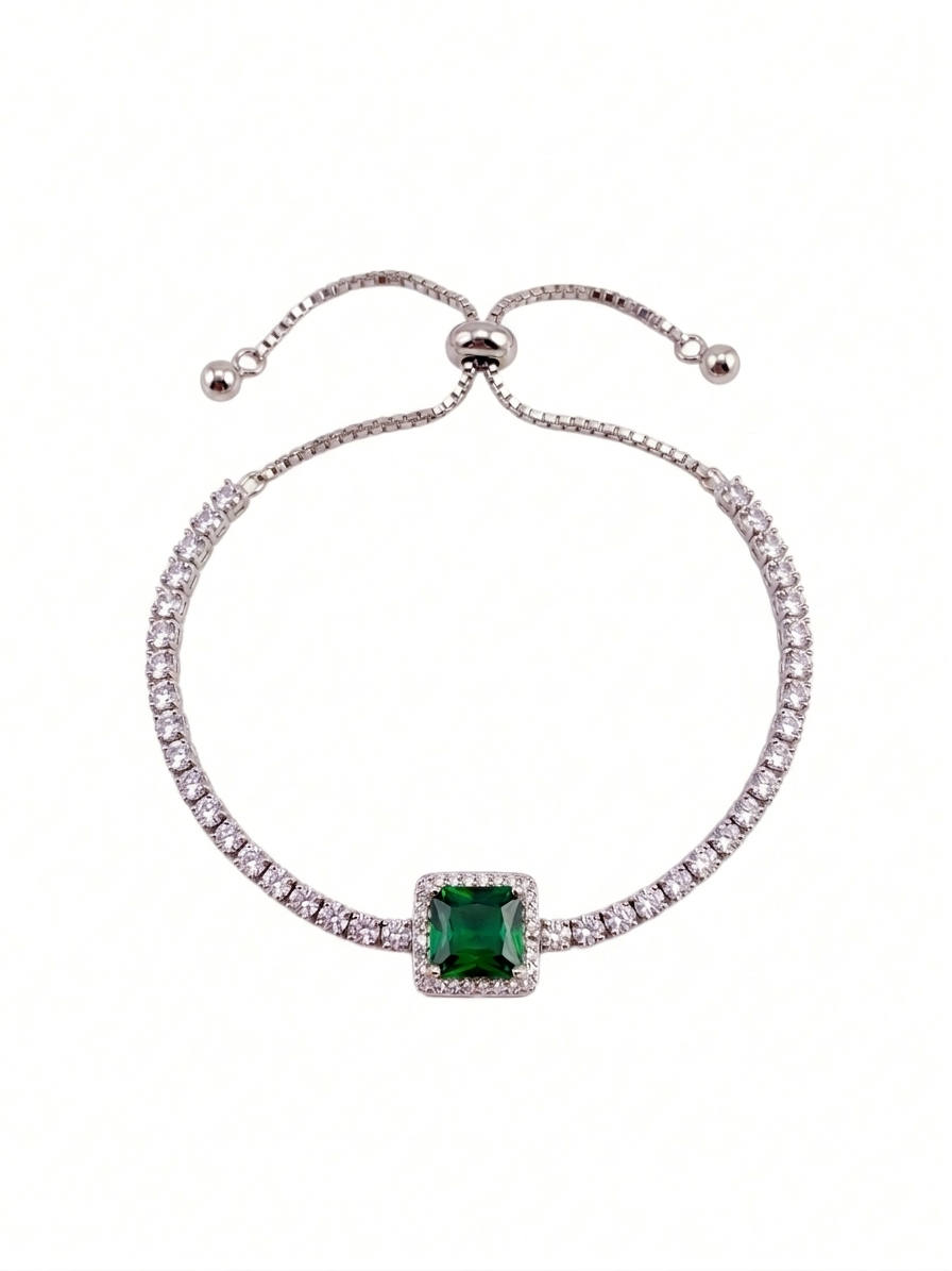 Bracelet with a green gemstone and clear stones on a white background