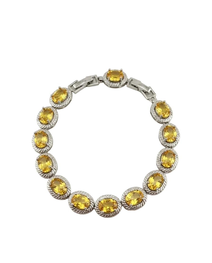 Silver bracelet with yellow gemstones on a white background