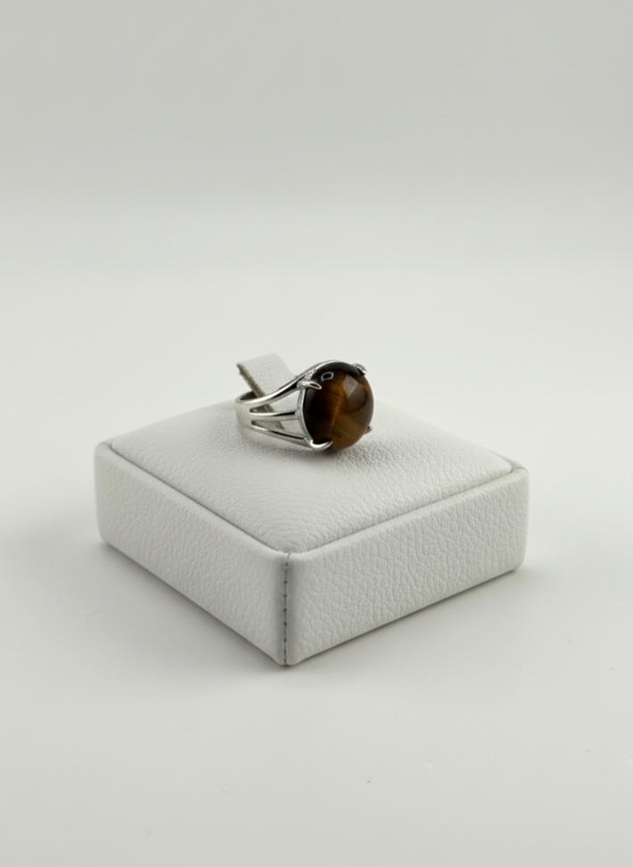 Silver Tiger Eye gemstone ring displayed on prop