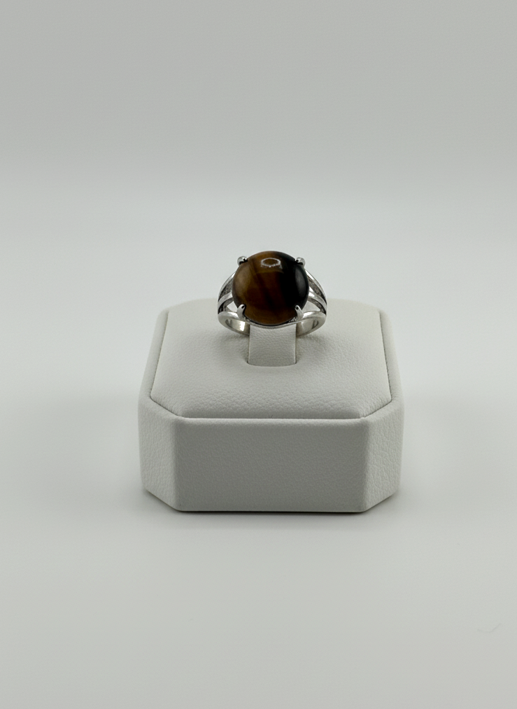 Silver Tiger Eye gemstone ring displayed on prop