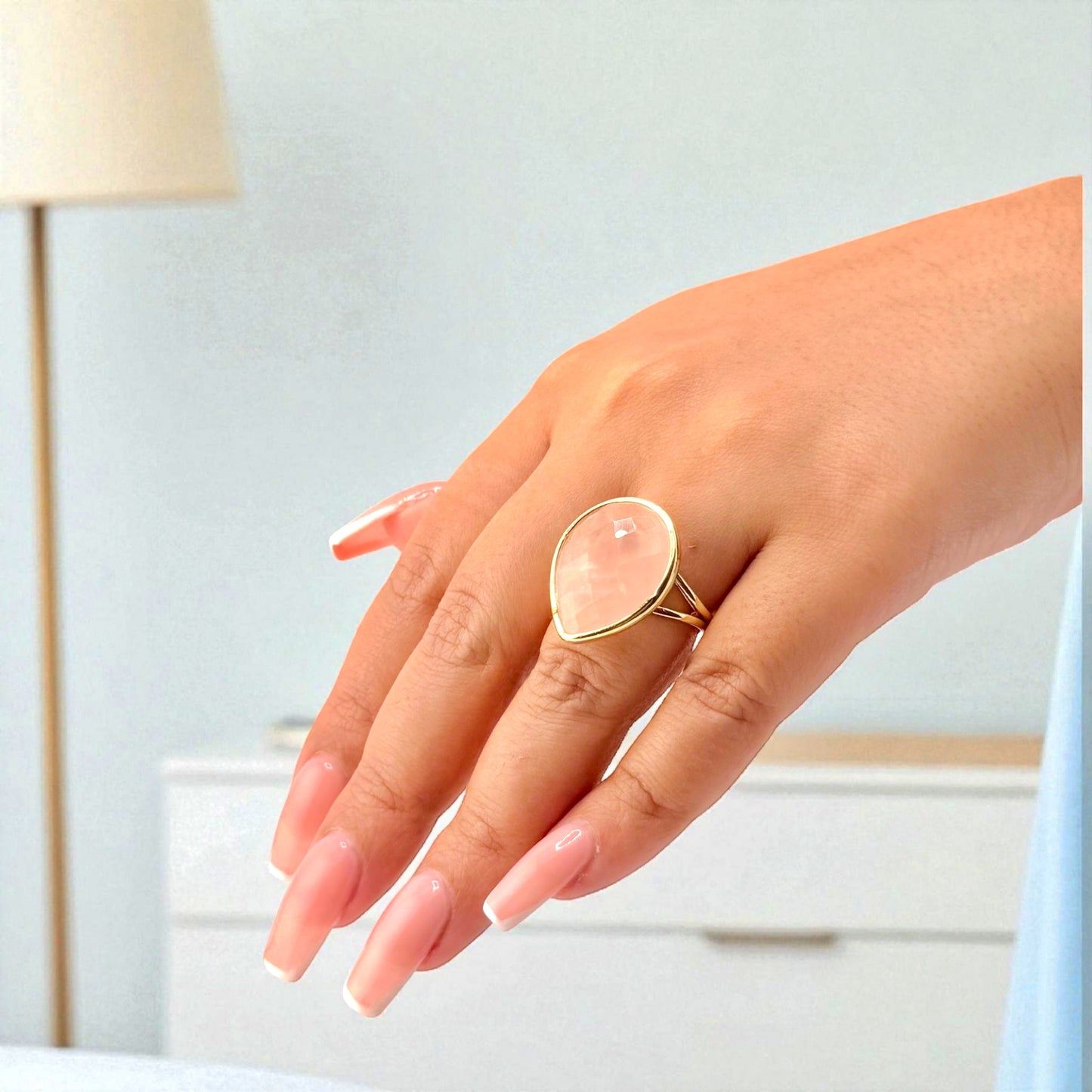 rose quartz teardrop ring on hand