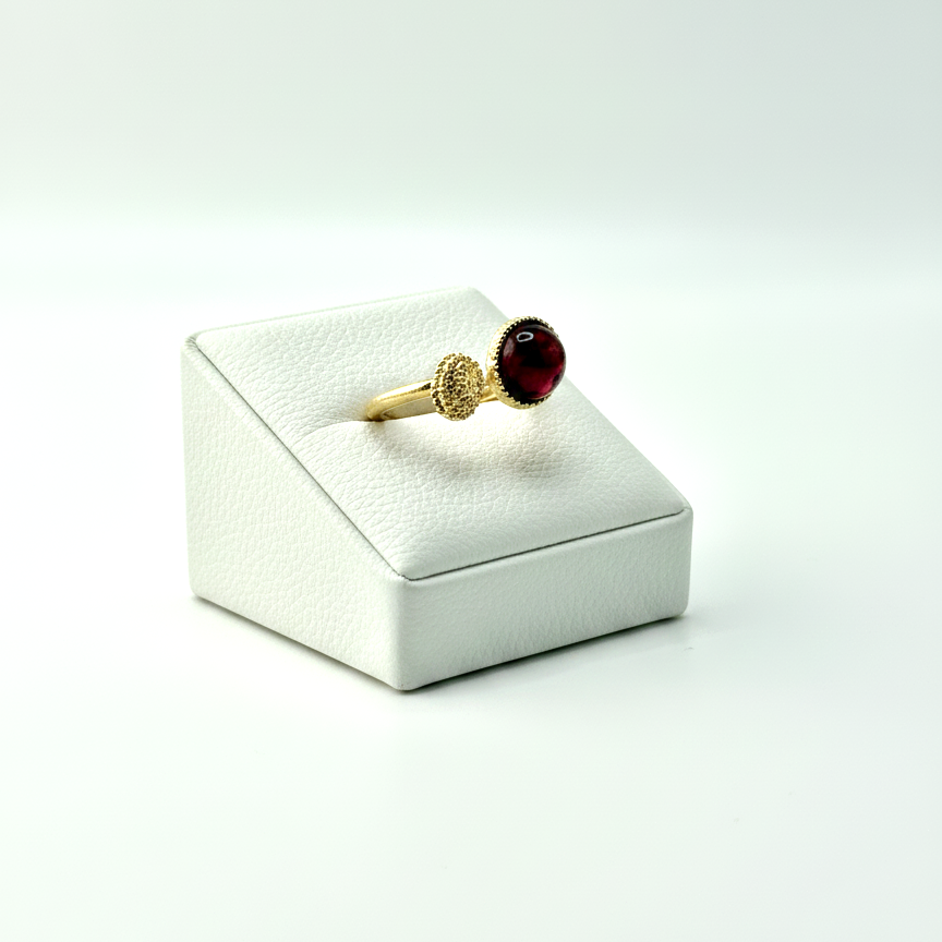 gold open band ring with garnet