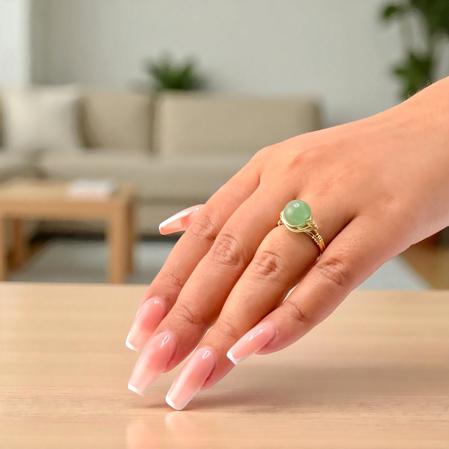 green aventurine ring on hand