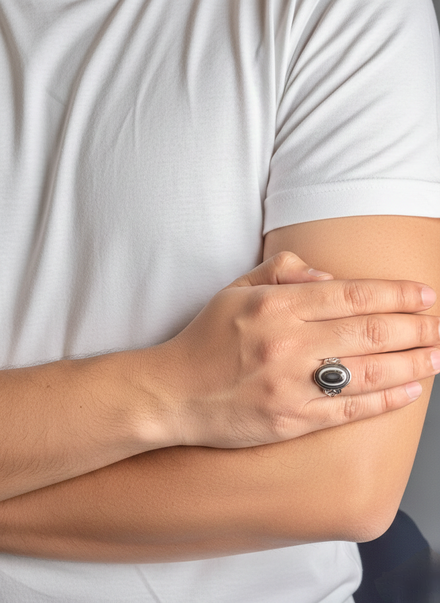 Close up of Black Onyx gemstone ring on a man’s hand