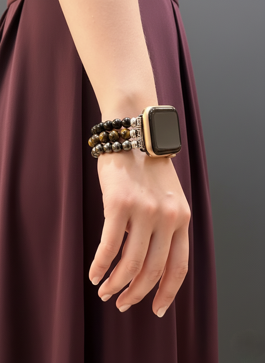 Hand wearing a smartwatch with a bracelet on a plain background