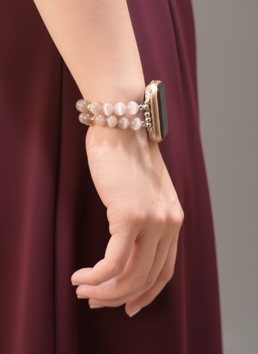 Hand wearing a pearl bracelet with a blurred background