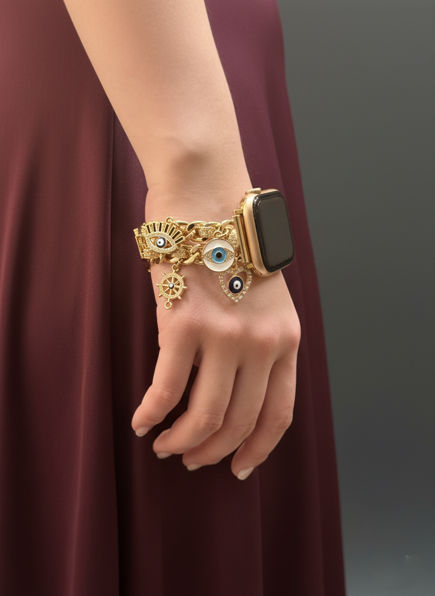 Hand wearing a gold bracelet with decorative elements on a plain background
