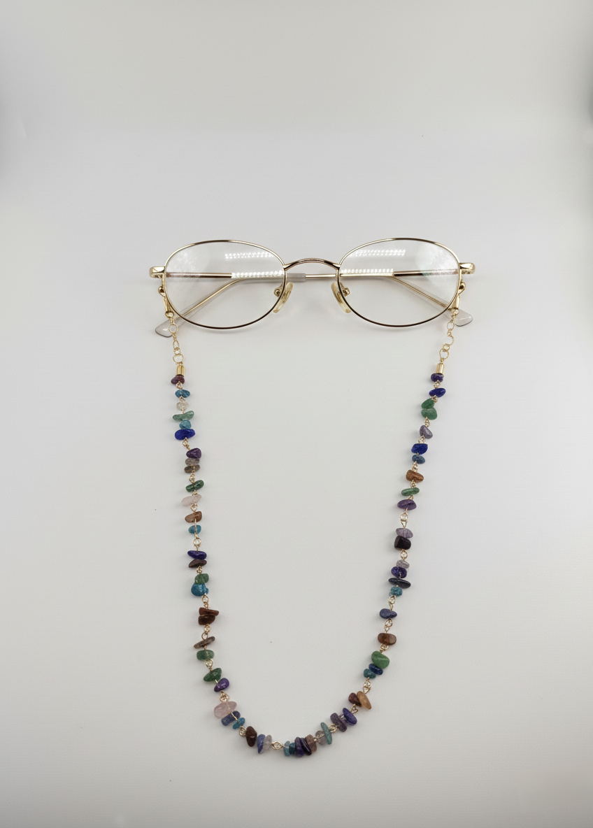 Glasses with a colorful beaded chain on a light gray background