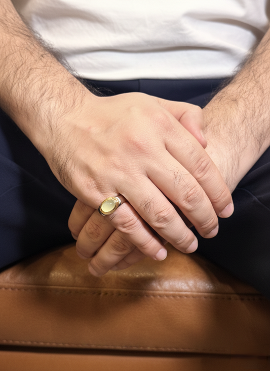 Close-up of hands with a gold ring on a brown surface