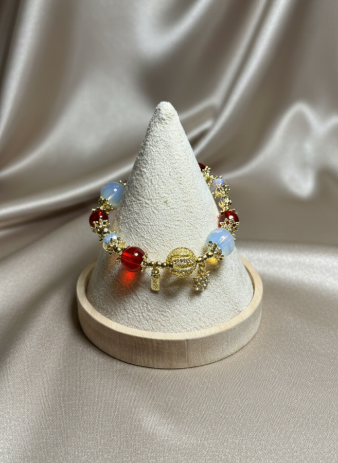 Bracelet with colorful beads on a cone-shaped display stand against a satin background