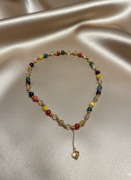 Multicolored beaded bracelet on a satin surface