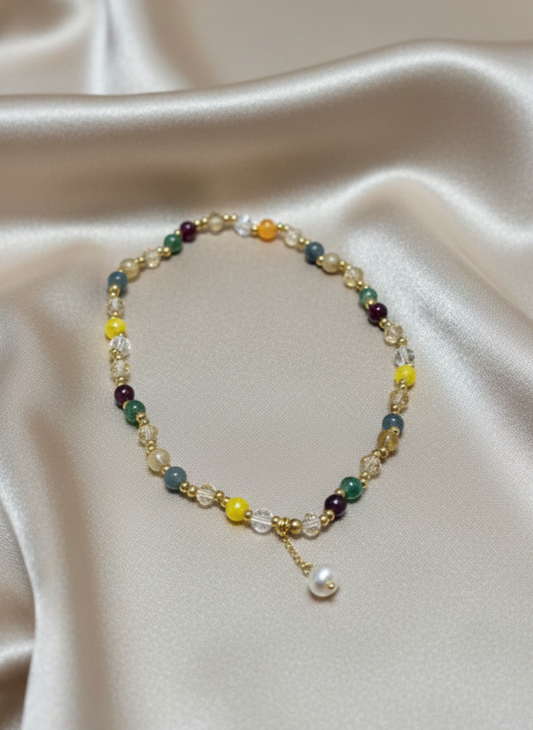 Multicolored beaded necklace on a beige fabric background