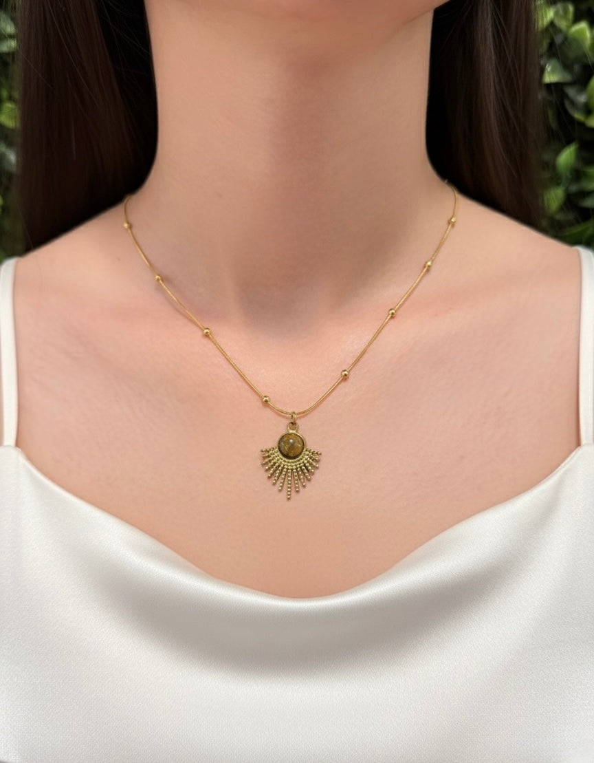 woman wearing gold plated tiger eye necklace with sunburst pendant