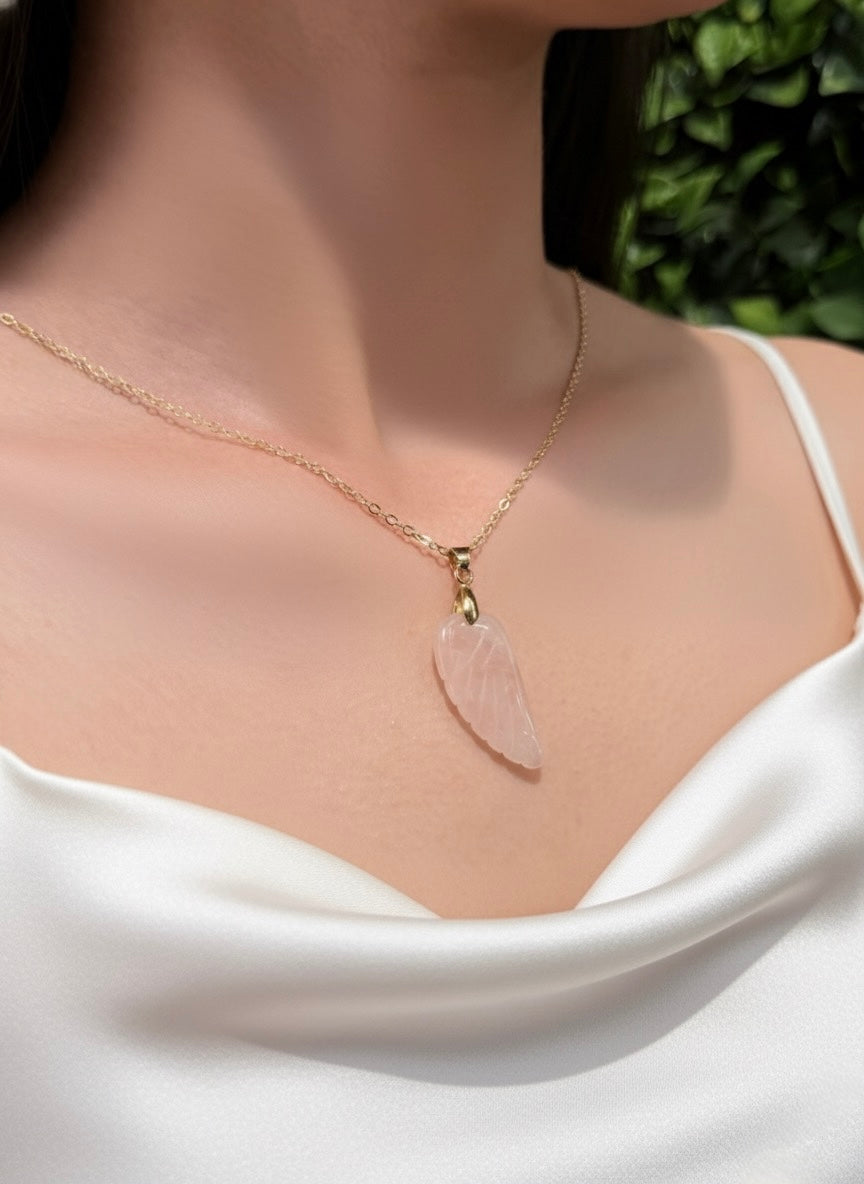 carved rose quartz angel wing pendant with gold chain