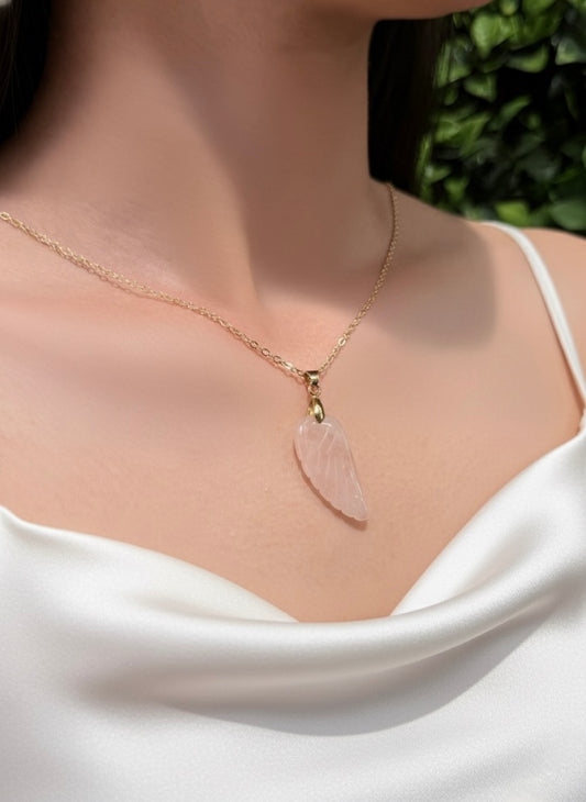 carved rose quartz angel wing pendant with gold chain