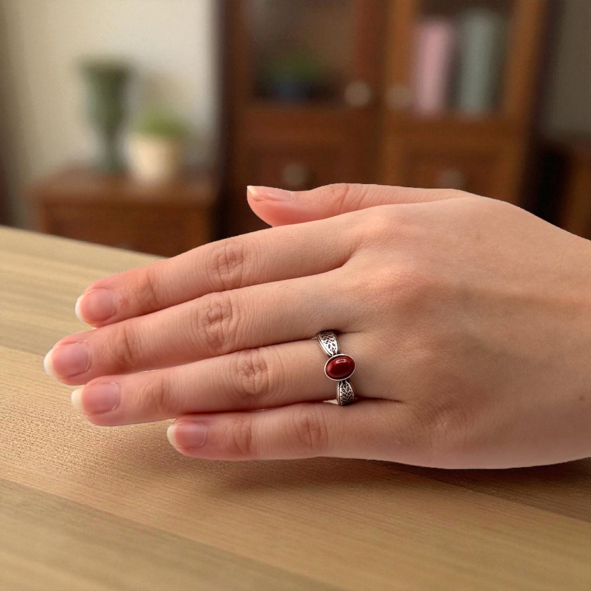 red jasper oval ring on hand