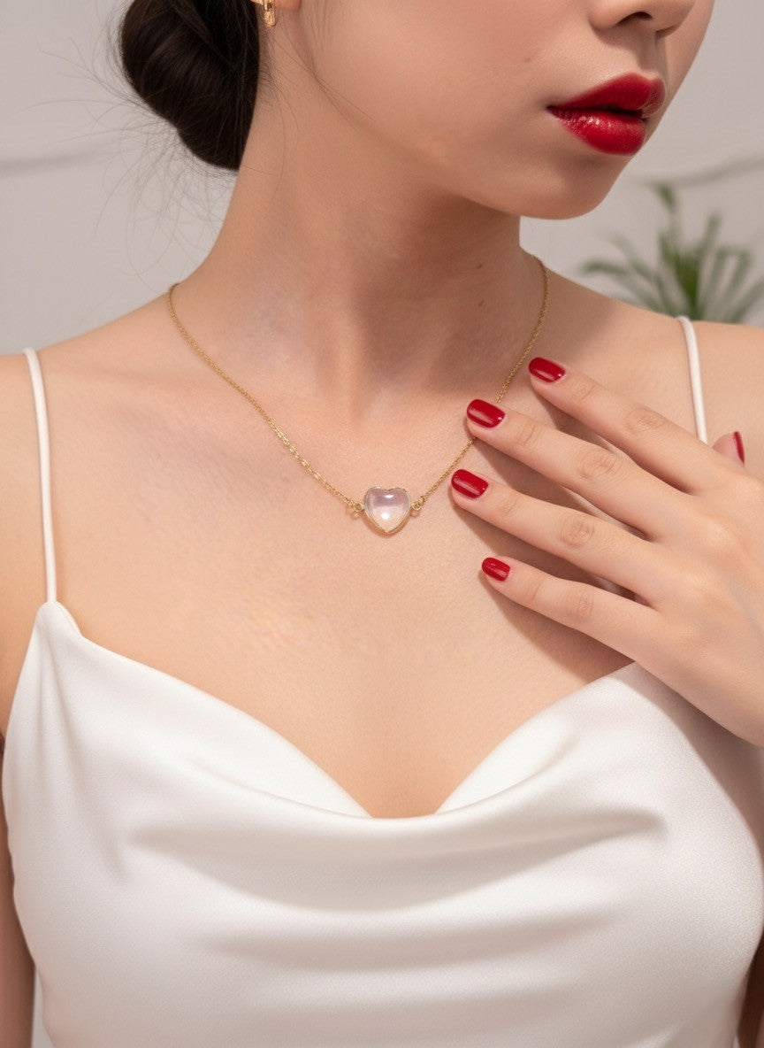 moonstone heart necklace on model with red nails