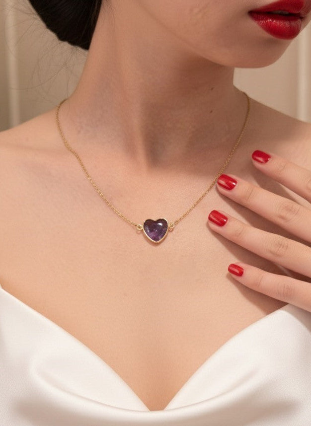 woman wearing amethyst heart necklace