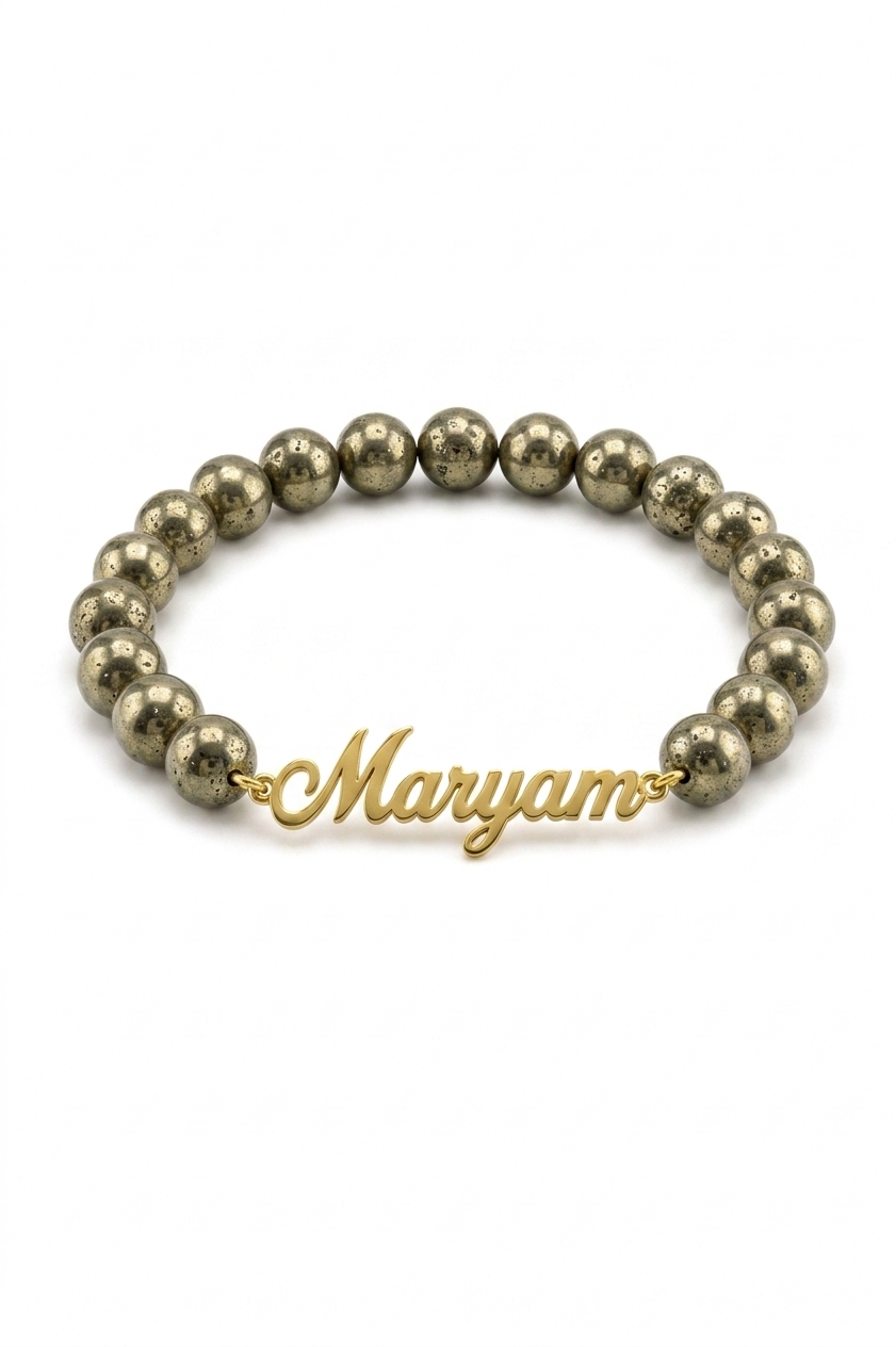 Gold beaded bracelet with a gold name charm on a white background