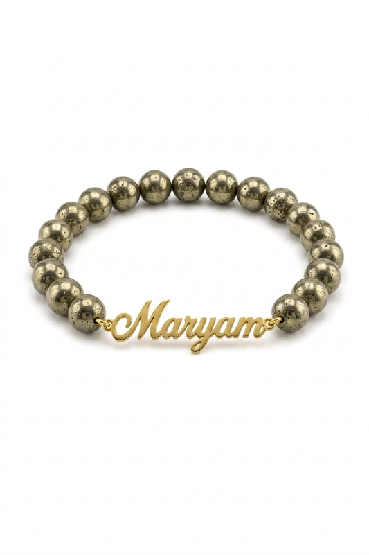 Gold beaded bracelet with a gold name charm on a white background