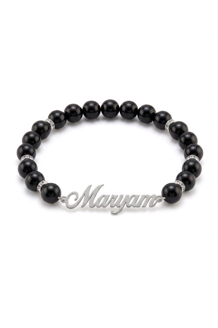 Black beaded bracelet with a silver nameplate on a white background