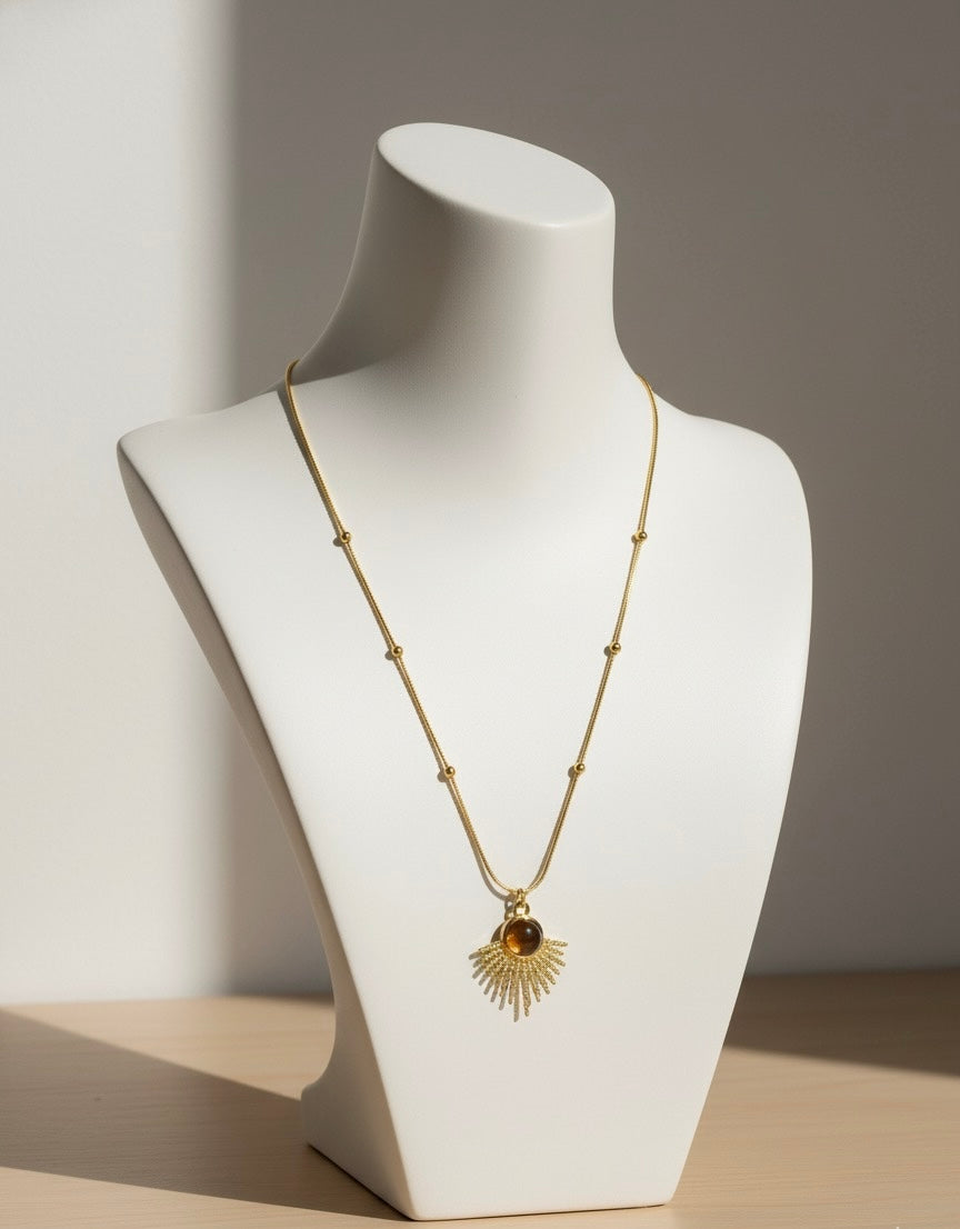 tiger eye sunburst necklace displayed on neckline for product showcase
