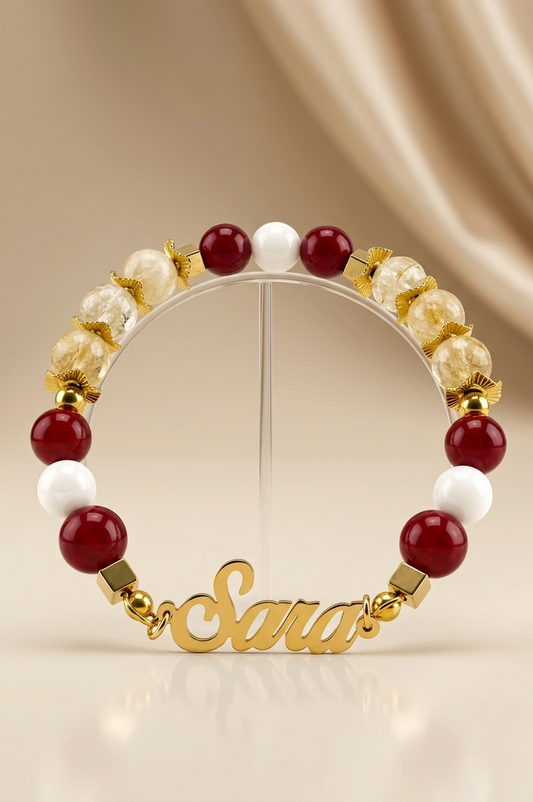 Bracelet with red, white, and gold beads on a beige background