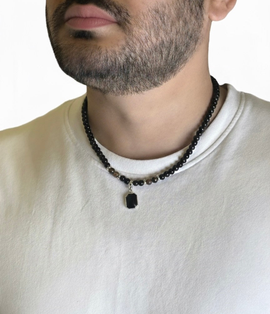 Black Onyx Tiger Eye Necklace with rectangular pendant on white shirt