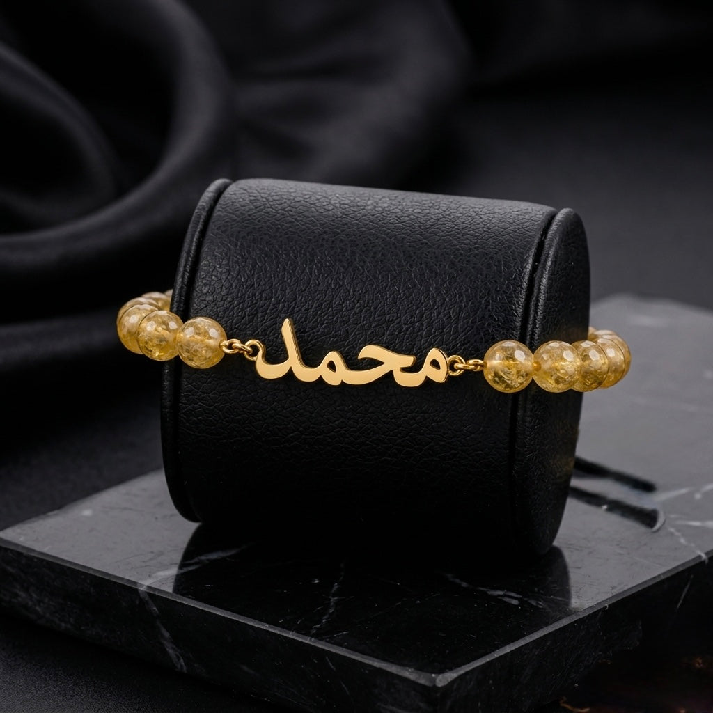 Gold bracelet with beads on a black surface