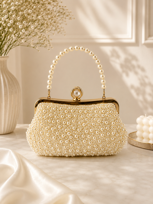 Pearl-handled handbag on a table with decorative elements