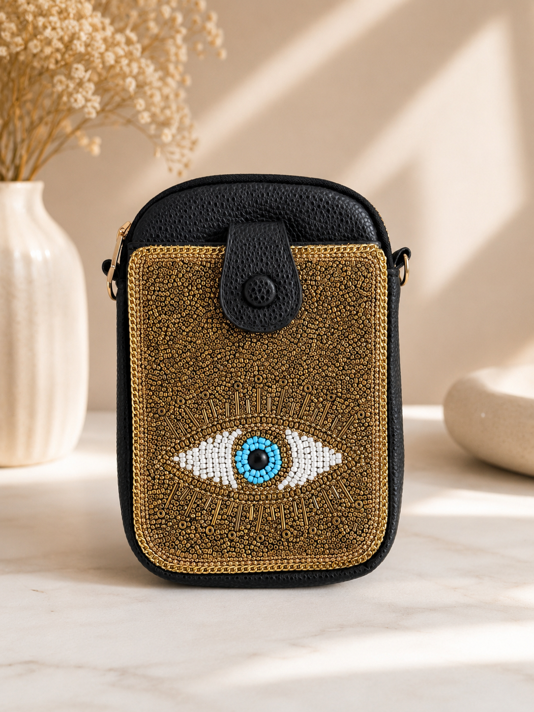 Small handbag with eye design on a neutral background