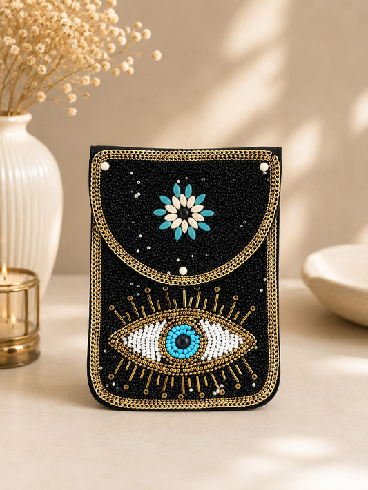 Decorative phone case with eye and floral design on a neutral background
