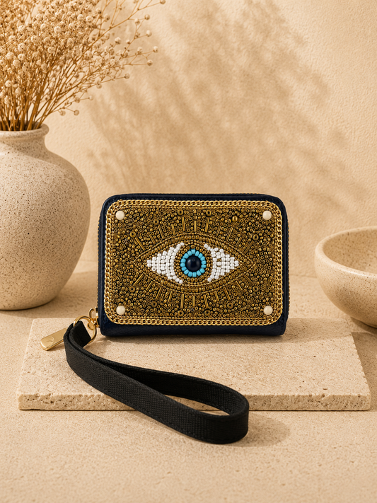 Decorative wallet with eye design on a neutral background