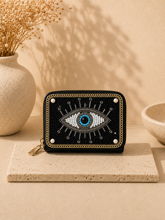 Small pouch with eye design on a beige surface with decorative elements