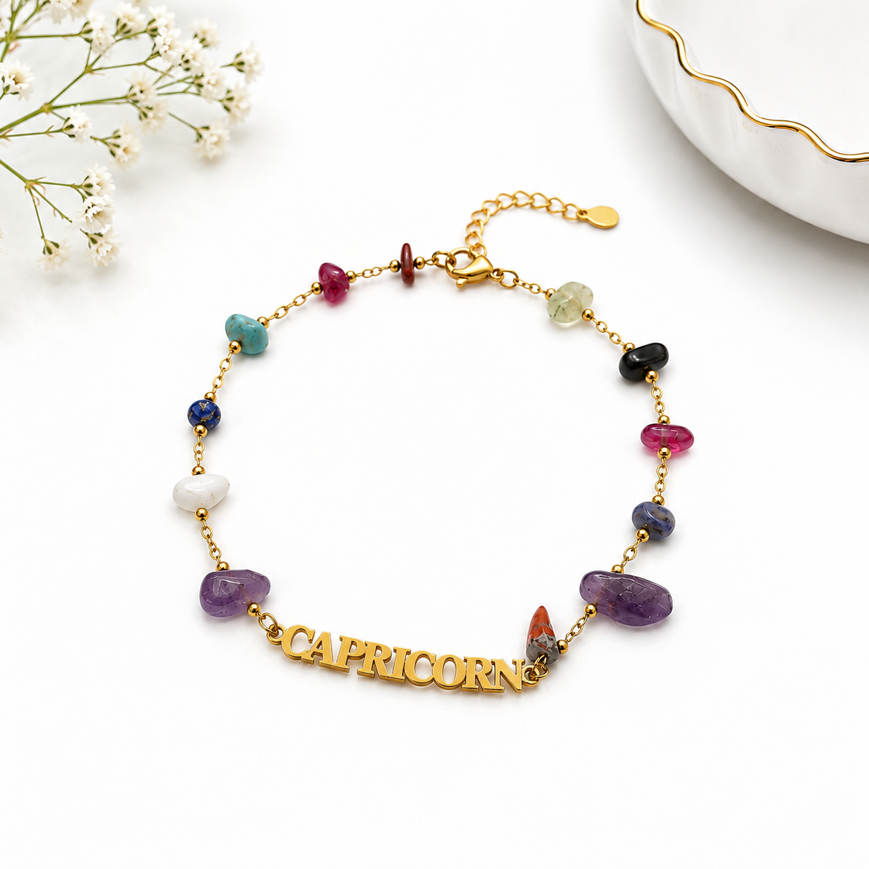 Multicolored gemstone bracelet with 'Capricorn' charm on a white background