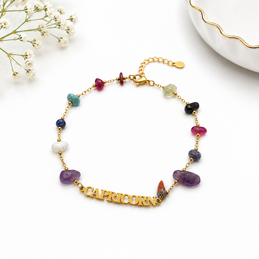 Multicolored gemstone bracelet with 'Capricorn' charm on a white background