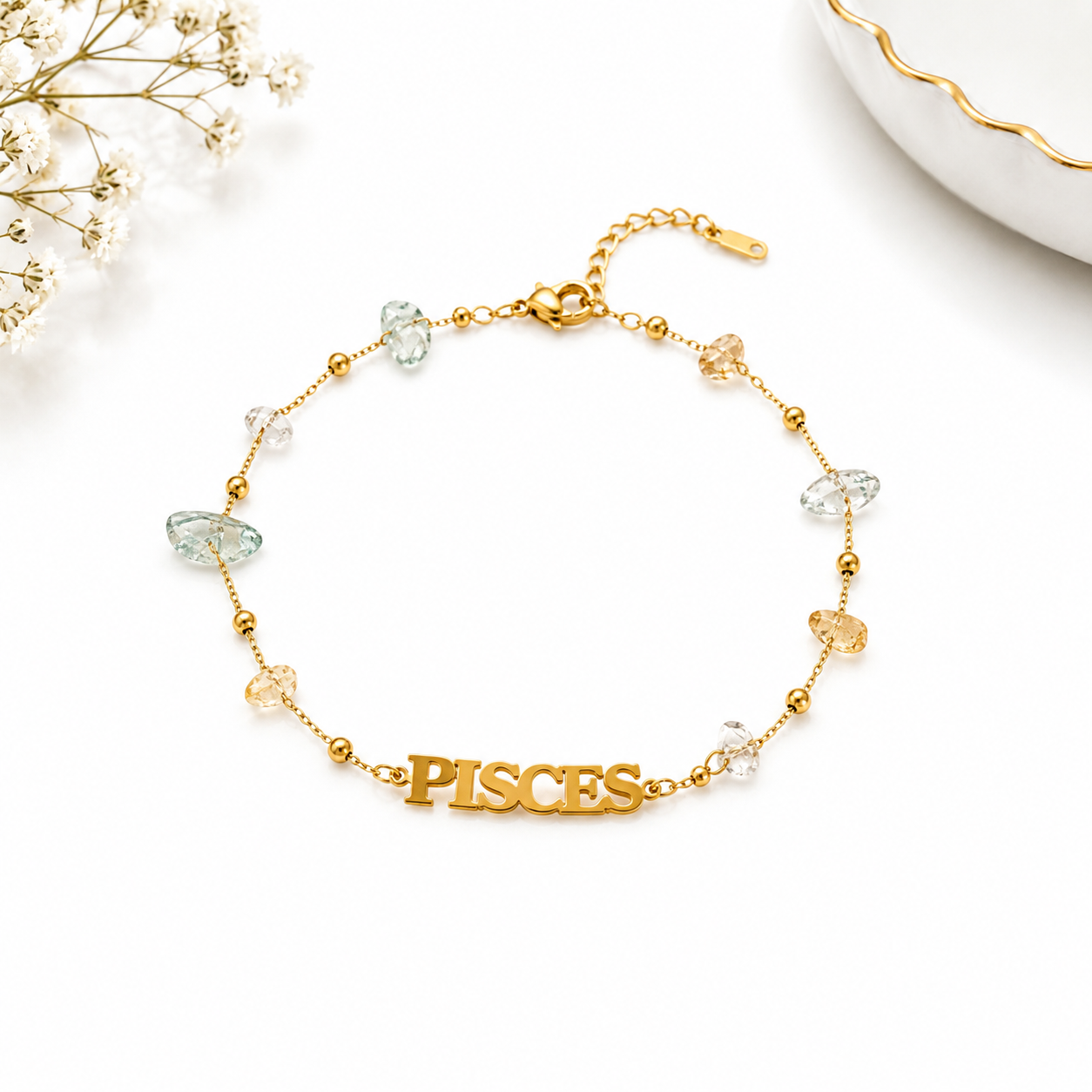 Gold bracelet with 'PISCES' inscription on a white background