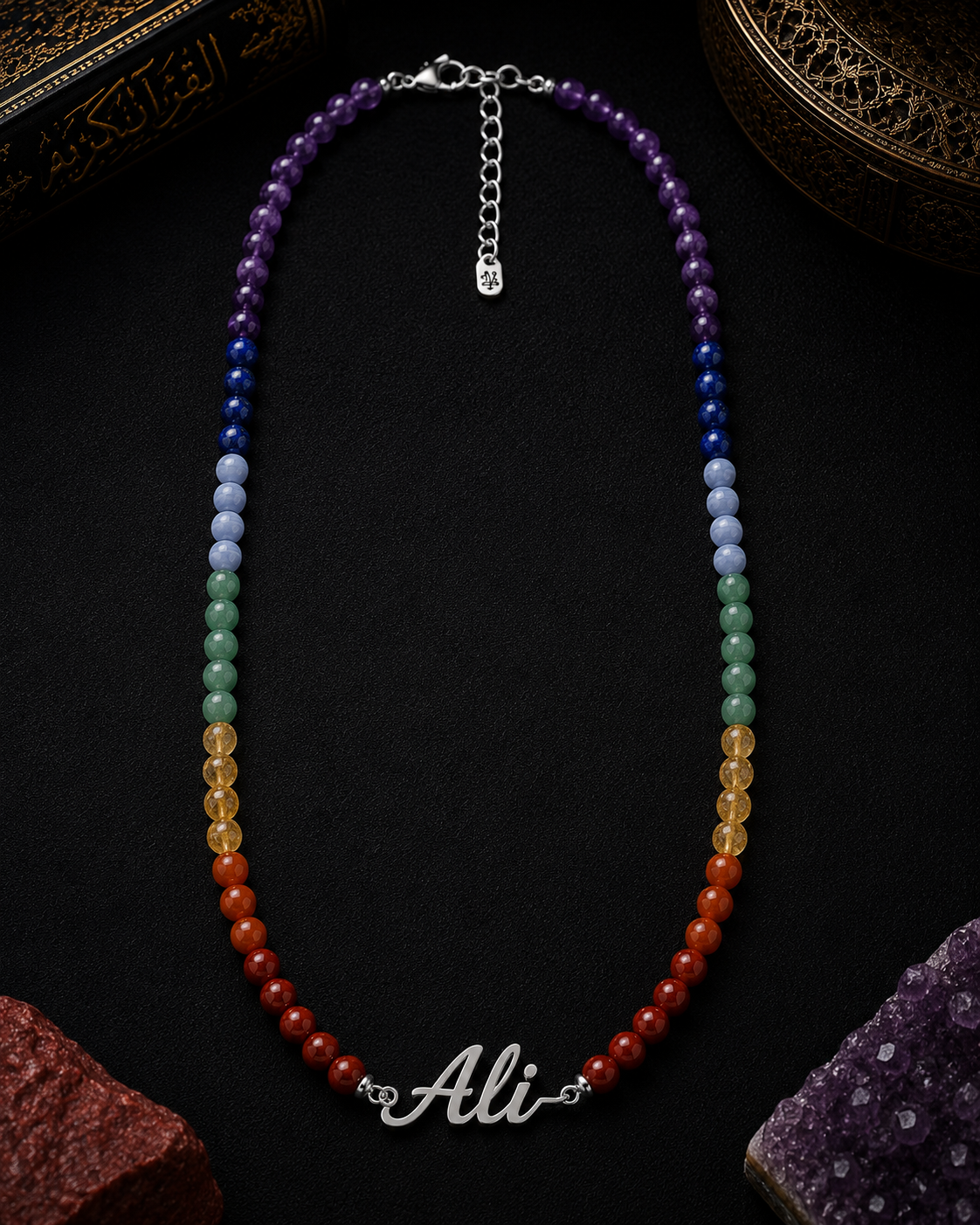 Colorful beaded necklace with a nameplate on a dark surface