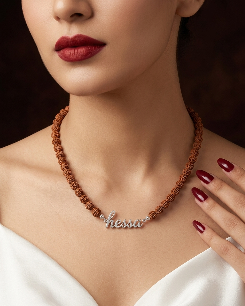 Necklace with 'hesper' pendant worn by a model against a dark background