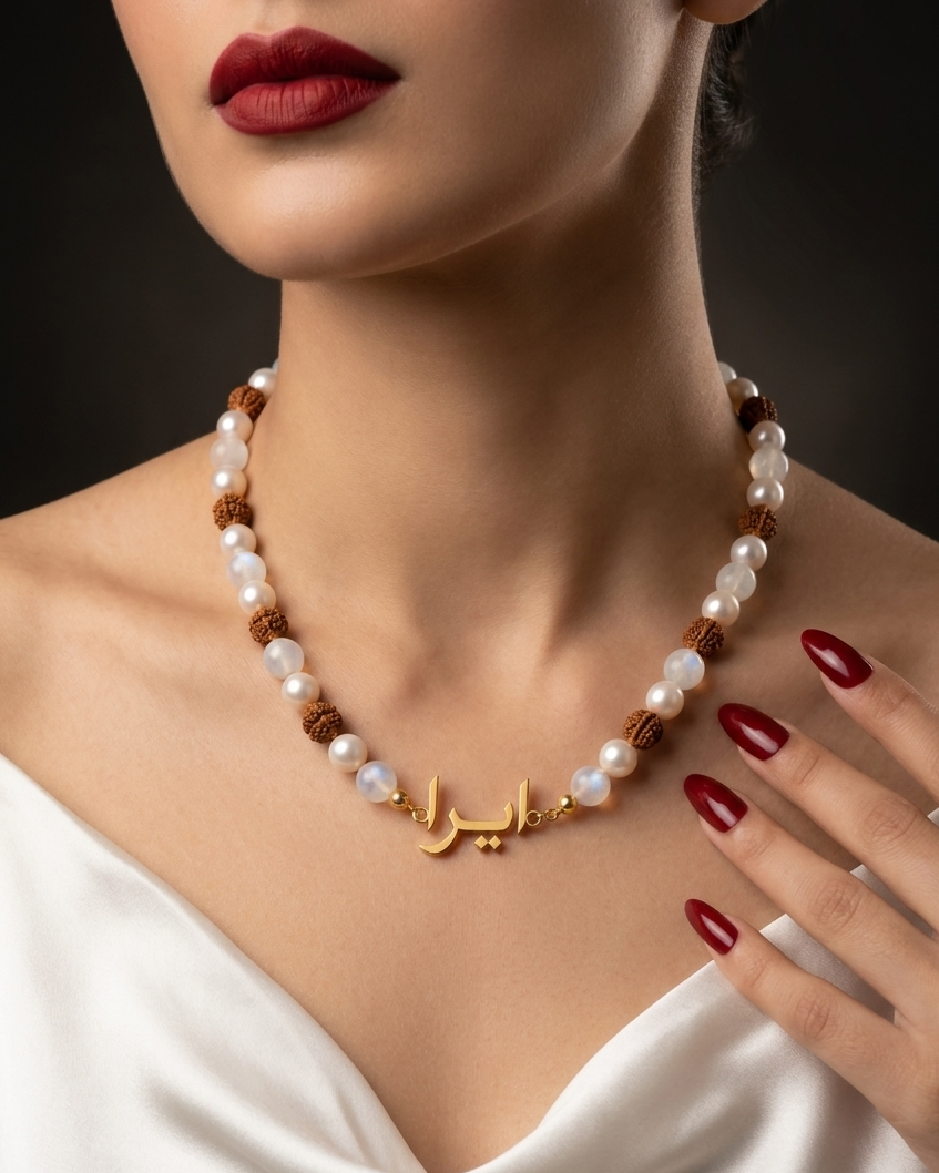 Pearl necklace with gold accents worn by a model against a dark background