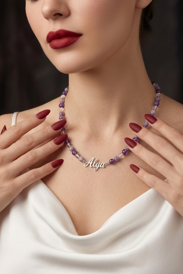 Woman wearing a 'Allya' necklace with a dark background