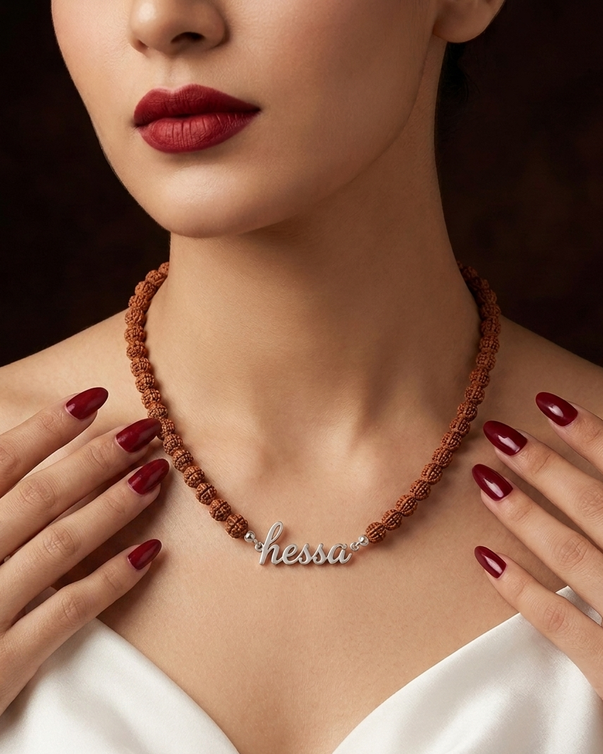 Woman wearing a necklace with 'hesper' pendant, close-up of neck and chest.