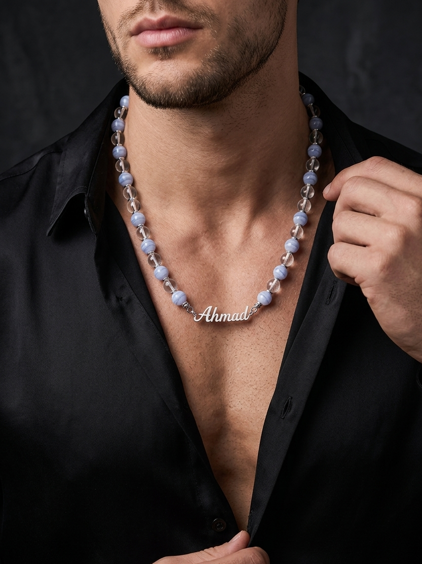 Man wearing a black shirt with a necklace that reads 'Ahmad'.