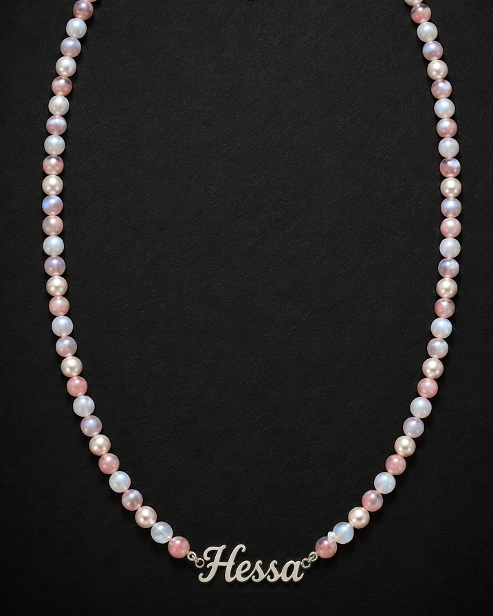 Pearl necklace with 'Hessa' branding on a black background