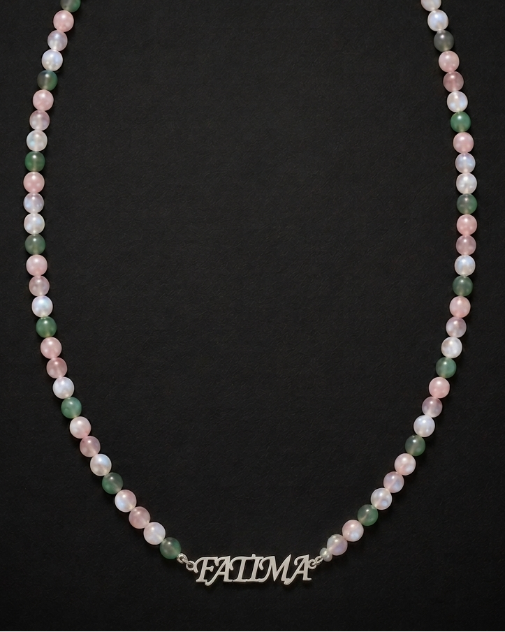 Necklace with multicolored beads and a nameplate on a black background