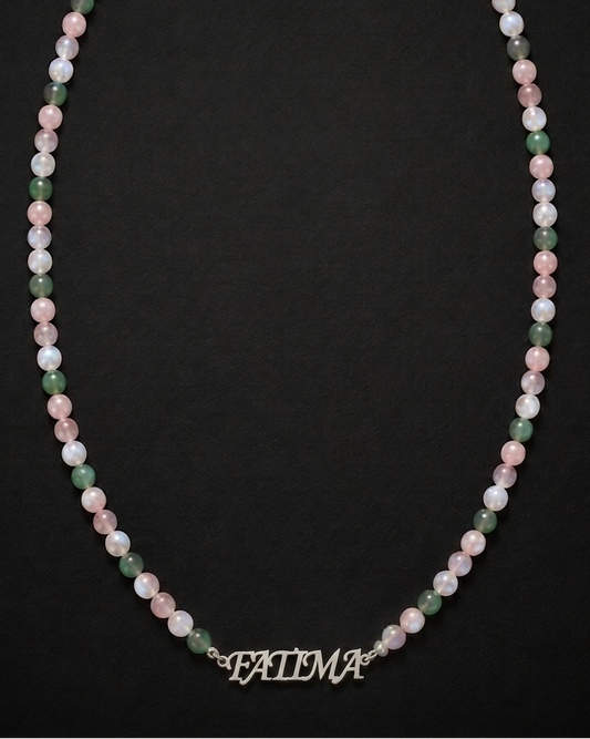 Necklace with multicolored beads and a nameplate on a black background