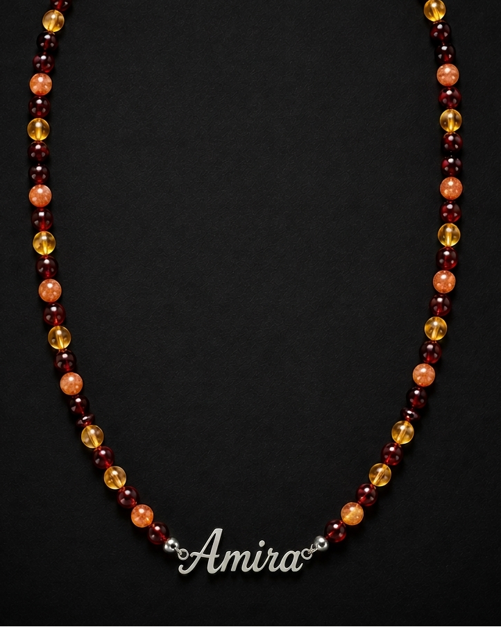 Necklace with multicolored beads and 'Amira' clasp on a black background