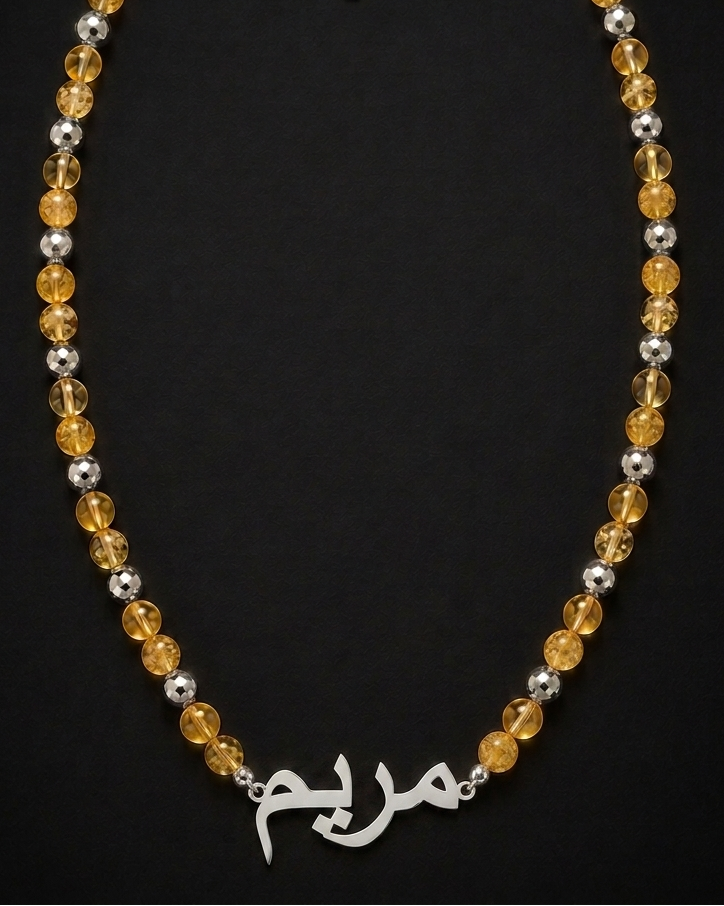 Necklace with yellow and silver beads on a black background